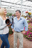 Couple laughing at flower pot shaped like boot
