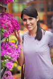 Smiling woman about to smell flowers