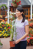 Woman smelling a daisy plant