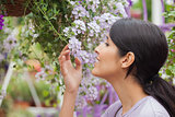 Woman smelling while holding a flower