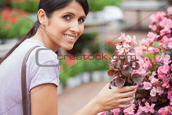 Woman smiling while holding a flower