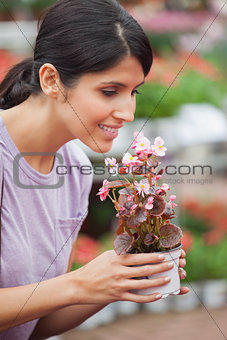 Woman holding a flower and smelling