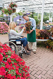 Woman in wheelchair buying a flower