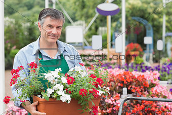 Man holding pot with flowers