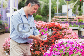 Man picking up a flower
