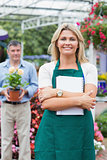 Customer holding a flower with woman holding a notepad