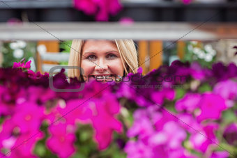 Woman looking through flower shelf
