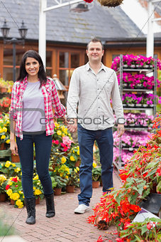 Couple holding hands in garden center