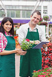 Happy workers with tablet pc in garden center