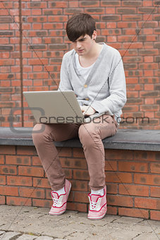 Man working on his laptop outside