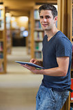 Man leaning against bookshelf at the library