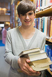 Student standing at the bookshelf
