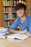 Student sitting at desk while smiling