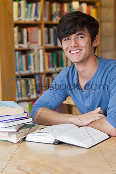 Student sitting at desk while smiling