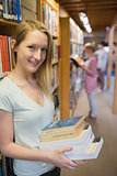 Student standing at a bookshelf