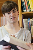 Man being shown book in library