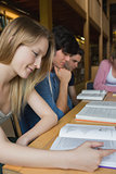 Students studying around library table