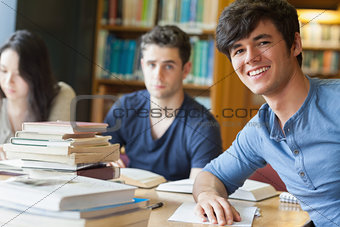Student leaning at the table smiling