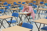 Student sitting at desk thinking