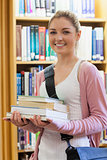 Woman smiling holding books