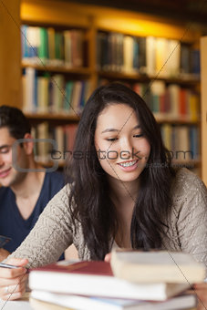 Student sitting at table smiling