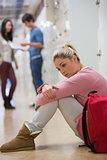 Student sitting on the floor at the hallway