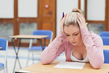 Woman looking at exam paper anxiously