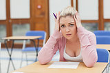 Woman looking worried over exam paper