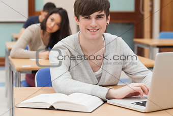 Student sitting at the classroom with laptop