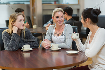 Students talking together in coffee shop