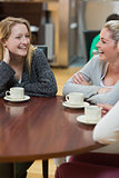 Women sitting at the coffee shop laughing