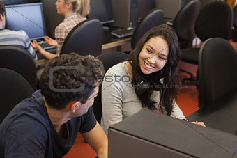 Couple sitting at the computer smiling
