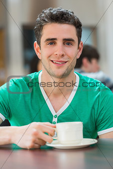 Man sitting holding a cup of coffee