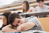 Student sitting at the lecture hall and sleeping