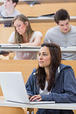 Girl sitting at the lecture hall concentrating