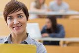 Teacher standing at the lecture hall smiling