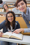 Smiling student and lecturer with book