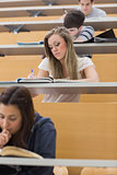 Students sitting at the lecture hall writing