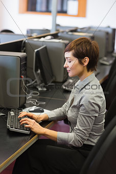 Concentrate woman sitting at the computer typing