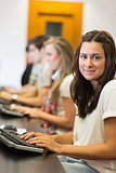 Woman sitting at the computer while smiling in college