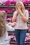 Child presenting flowers to her mother in garden center