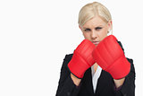 Serious blonde in suit wearing red gloves