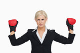 Serious businesswoman with red gloves arms raised