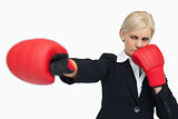 Blonde businesswoman with red gloves fighting