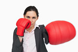 Serious woman wearing red gloves punching