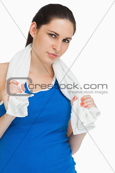 Brunette woman in sportswear with a towel