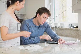 Young couple calculating