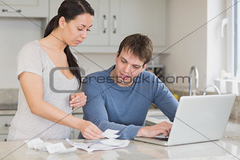 Young couple calculating with the laptop