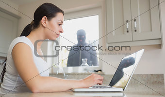 Young woman seeing reflection of robber