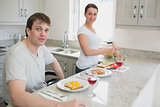 Happy couple having lunch in kitchen